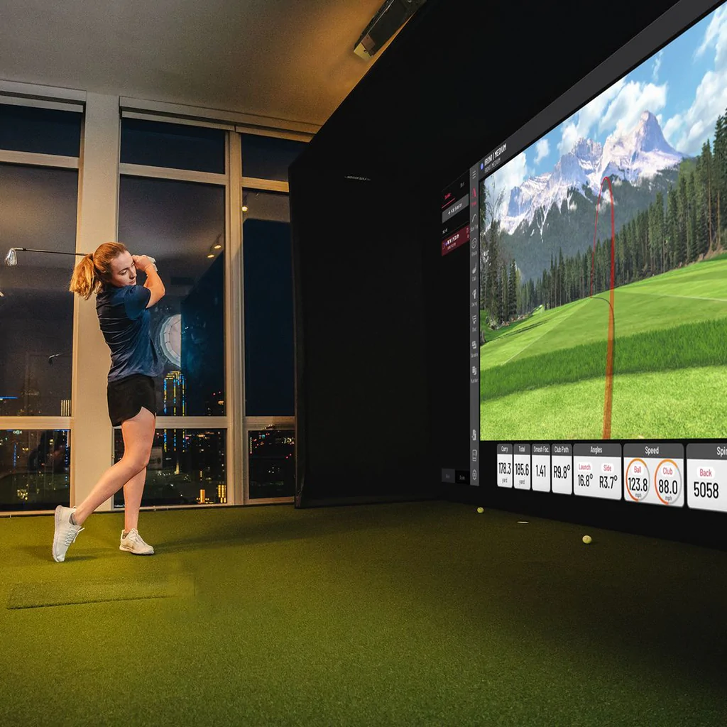 Golfer using uneekor eye xo with indoor golf shop enclosure 1024x1024