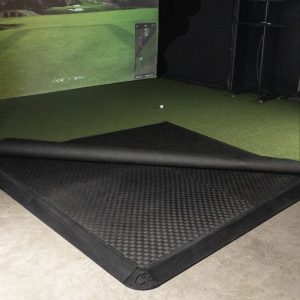 Carl's Golf Room Floor Tiles under turf in a simulator bay, turf rolled back